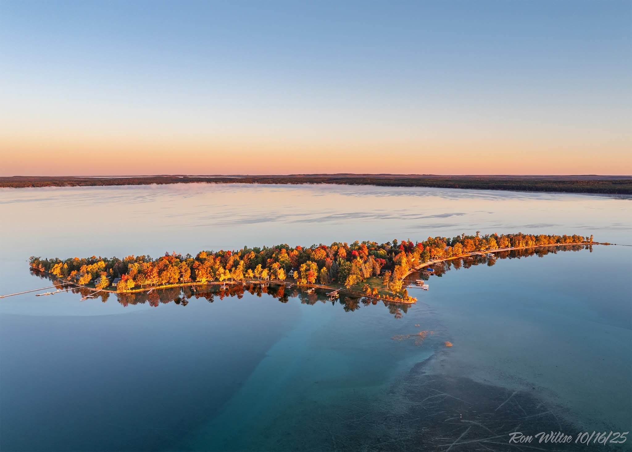 Aerial view of Higgins Lake Michigan peninsula at sunset - buying lakefront property guide