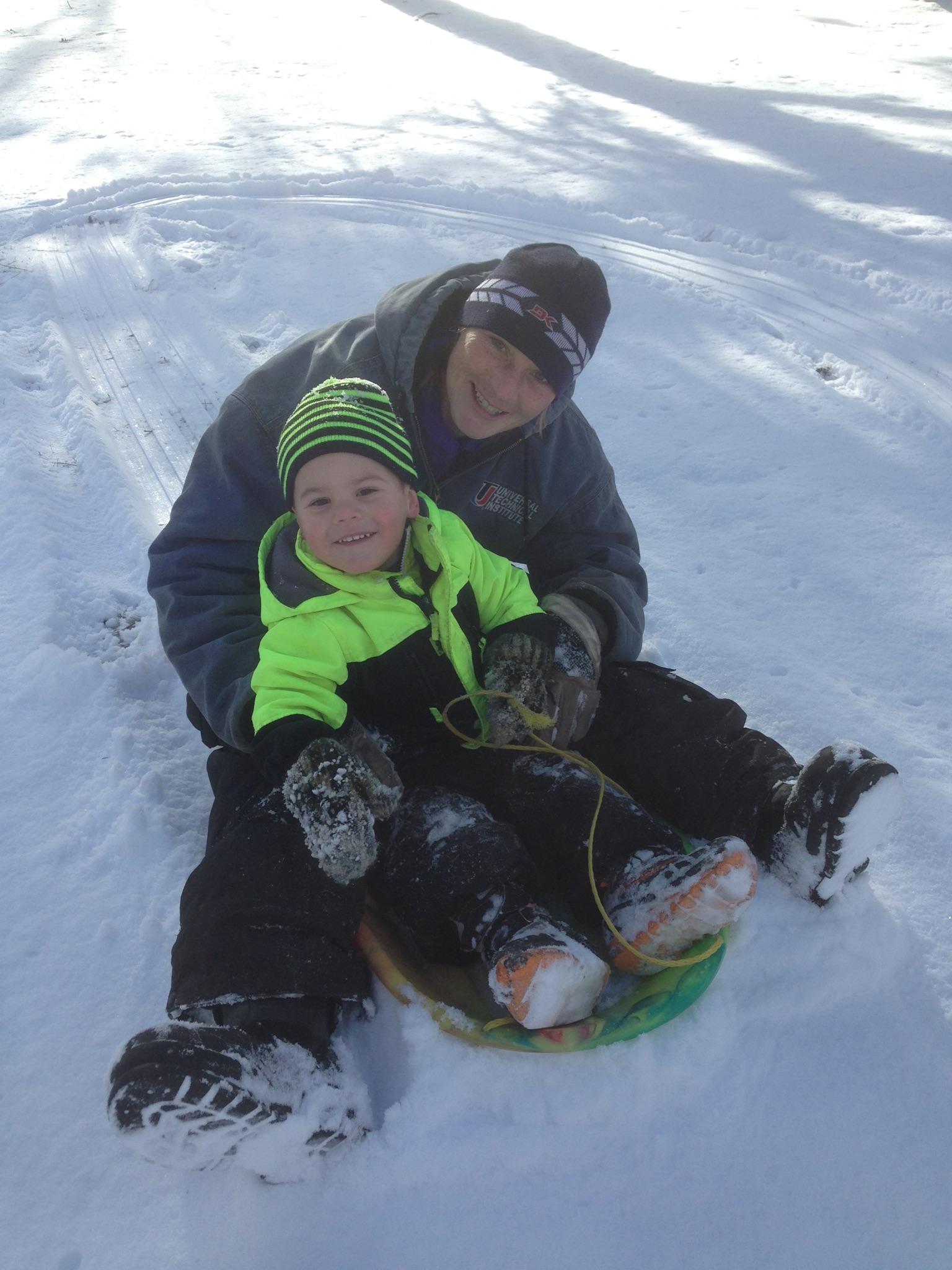 Sarah and Dylan Bohnsack sledding in Northern Michigan winter